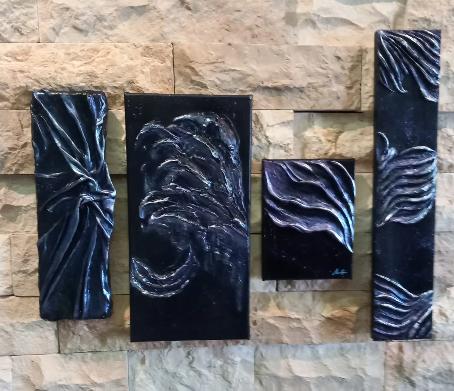 Four black panels with silver textured waves