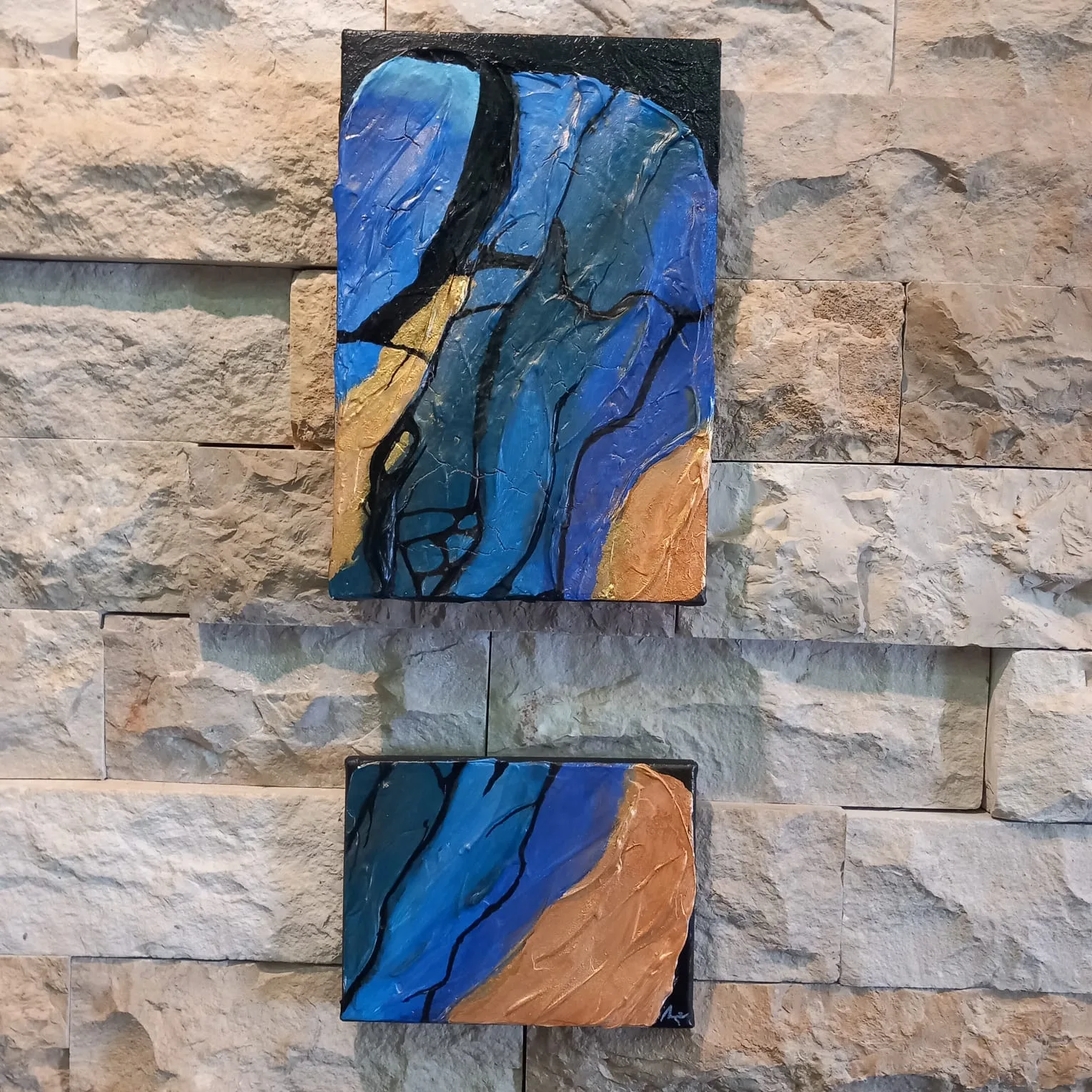 Two small panels of cracked rock in blue and orange